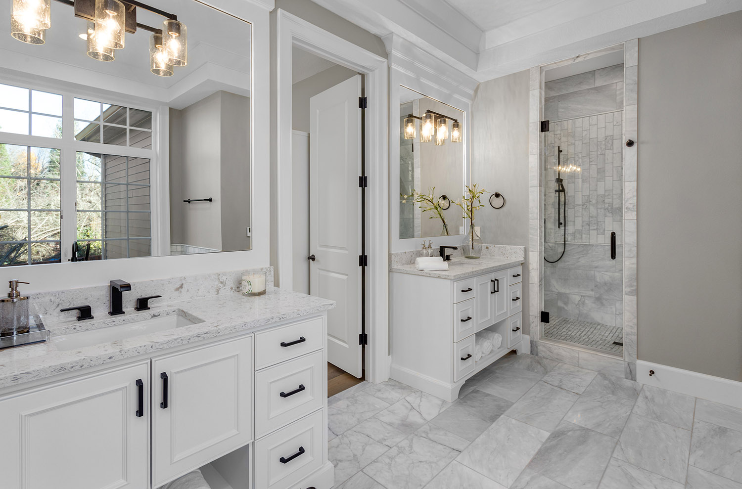 Beautiful bathroom in new luxury home with two vanities and sinks.