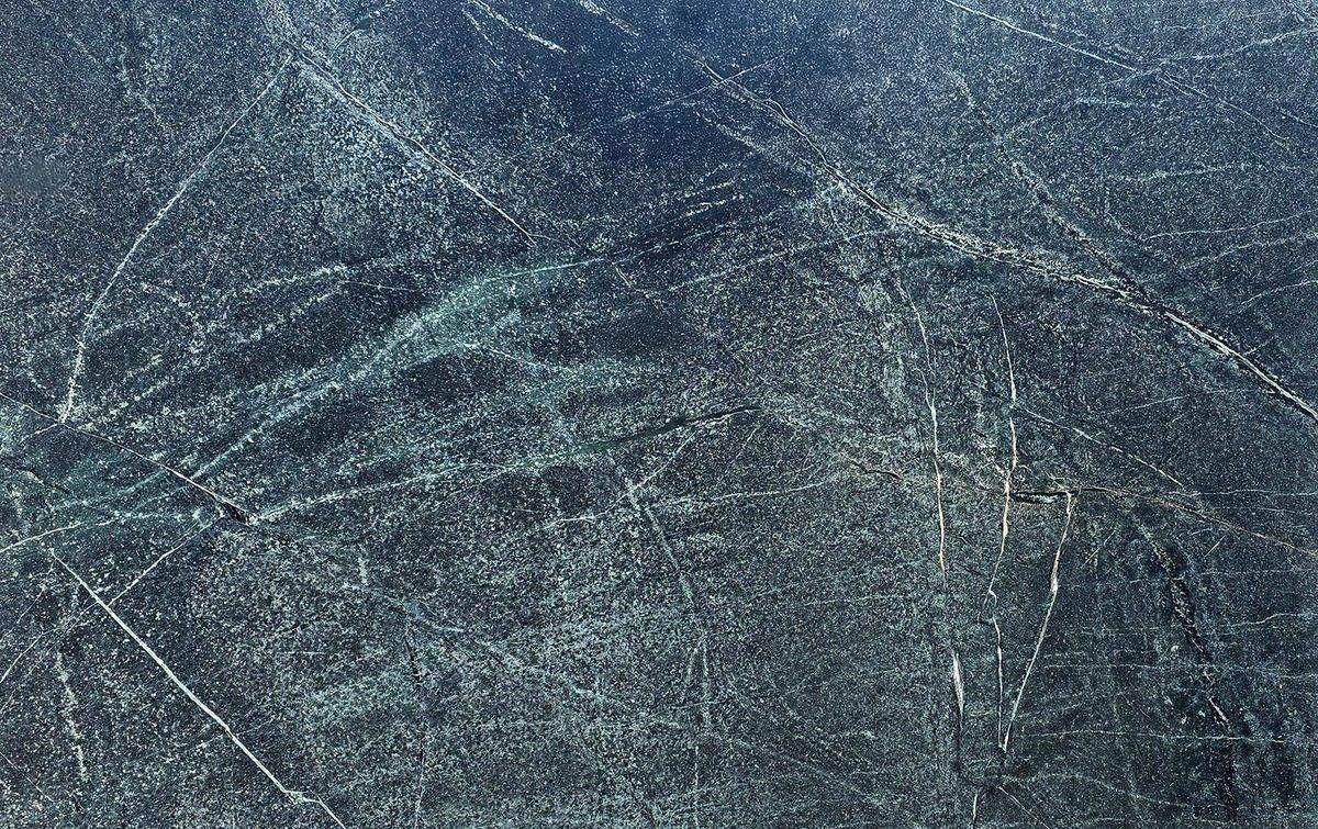Dark green-gray soapstone slab with thin white veins